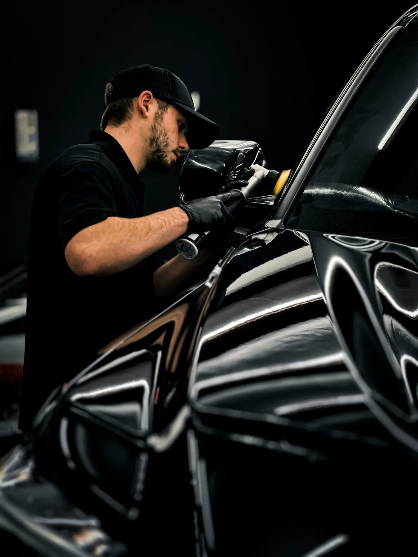 Technician polishing a vehicle